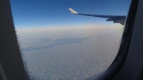 Wing of an airplane from the window in the sky with clouds Foto stock