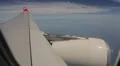 The wing and engine of an aircraft flying above the Indian Ocean HD Footage