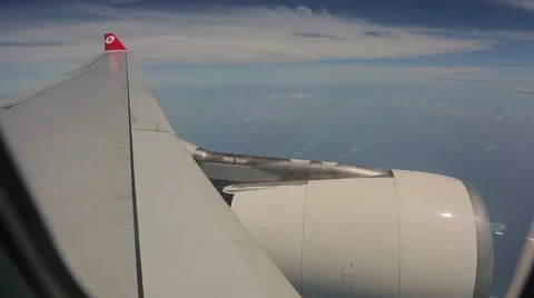 The wing and engine of an aircraft flying above the Indian Ocean Stock Footage 49365248