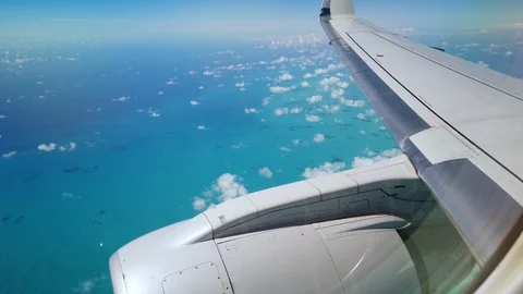 Wing and engine of an airplane flying over bahamas Stock Footage 110818499