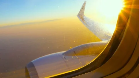 Wing and Engine of a Plane, Sunset Sky and Clouds Seen Through a Window Stock Footage 72182699