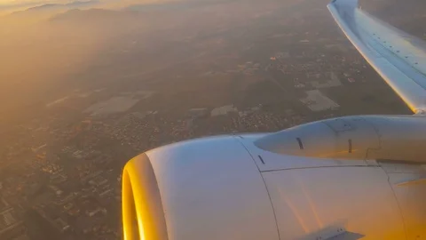 Wing and Engine of a Plane, Sunset Sky and Clouds Seen Through a Window Stock Footage 72182782