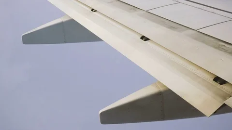 Wing and Engines of a Plane and Clouds Seen Through a Window While Flying Stock Footage 72167784