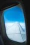 The wing on the background of the cloud. View from porthole Photo