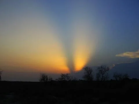 Wing-Like Cloud Formation Above Storm Clouds at Sunset Stock Photos