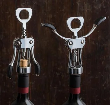 Wing Corkscrew Opening a Bottle of Wine on Wooden Background Stock Photos
