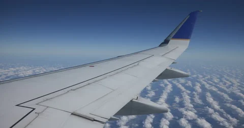 Wing During Flight with Rows of Clouds Below Stock Footage 222288447