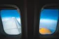 The wing with engine on the background of cloud. View from porthole Photo