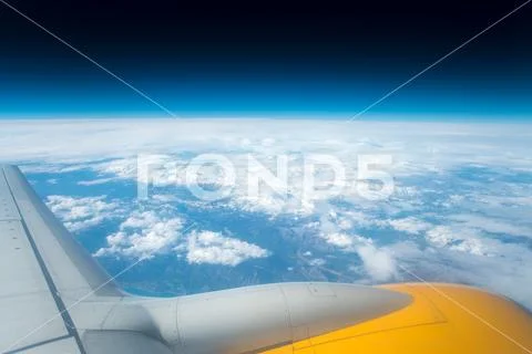 The wing with engine on the background of cloud view Stock Photos