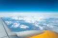 The wing with engine on the background of cloud view Photo