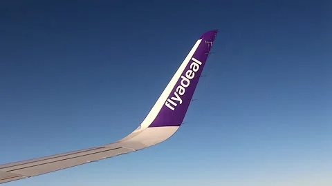 Wing of Flyadeal Airlines plane flying fover Jeddah near the Ihram zone, Saudi Stock Footage 255928448