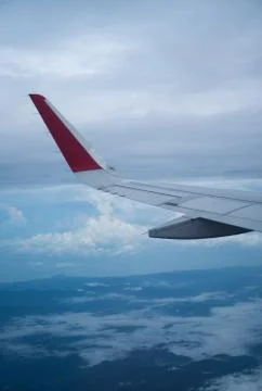 Wing of flying airplain Stock Photos