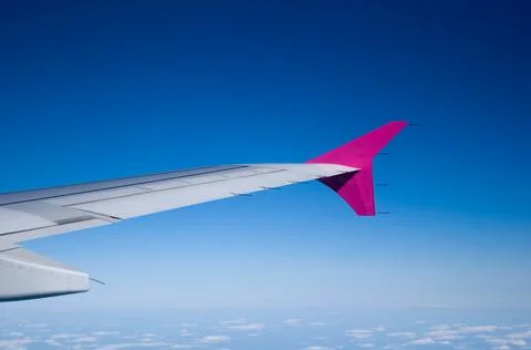 Wing of a flying plane from the plane's window Stock Photos