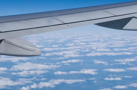 Wing of a flying plane from the plane's window Stock Photos