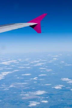 Wing of a flying plane from the plane's window Stock Photos