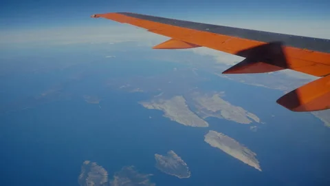 The wing of a flying plane at sunset Stock Footage 195083048