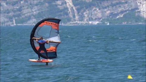 Wing-foil guy enjoying the ride, Lake Garda, Italy in the summer of 2020 Stock Footage