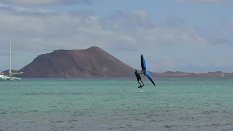 Wing Foiling at Playa de los Verilitos Corralejo, Lobos Island in the distance Stock Footage 301653083