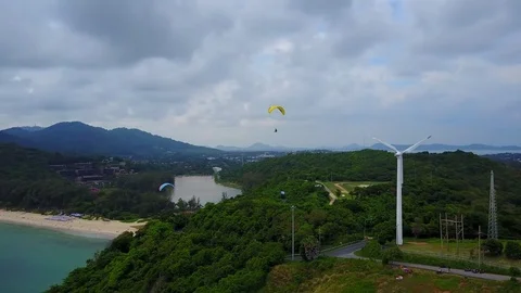 Wing of para-glider soaring over hill summit, adventure sport at sea shore Stock Footage 78533208