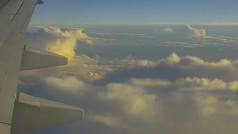 Wing of plane with amber clouds below alt Stock Footage 346875667