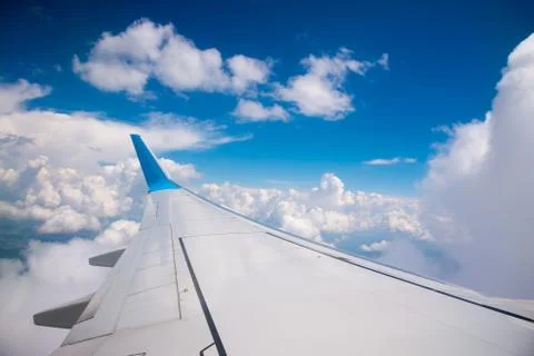 Wing of the plane on blue sky background Stock Photos