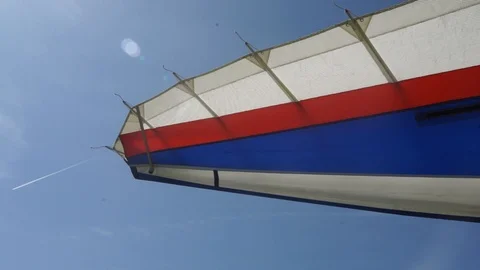 Wing of the plane in the blue sky, the plane flies, the sun in the eyes Stock Footage 127005212