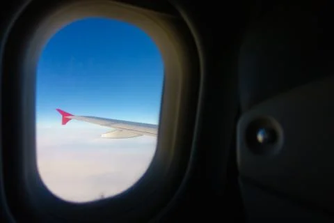 Wing of the plane can be seen through window Stock Photos