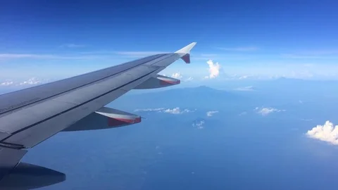 Wing of the plane with cloudy sky on the background Stock Footage 76843794