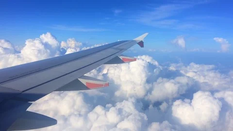 Wing of the plane with cloudy sky on the background Stock Footage 76843808