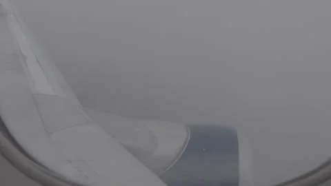 Wing of Plane Flying through Rain Clouds Stock Footage 154005629