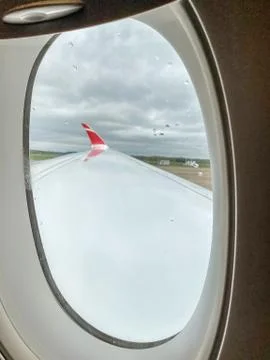 Wing of the plane from inside the cabin Stock Photos