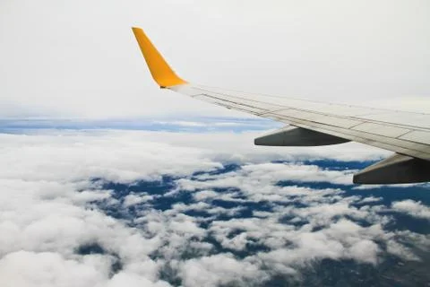 Wing of the plane on sky background - view from the window of a plane of the  Stock Photos