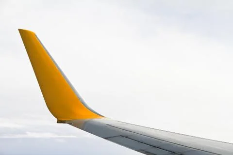 Wing of the plane on sky background - view from the window of a plane Stock Photos