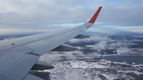 The wing of plane. View from the eluminator. Clouds fly by below. Winter. Lilac Stock Footage 151358584