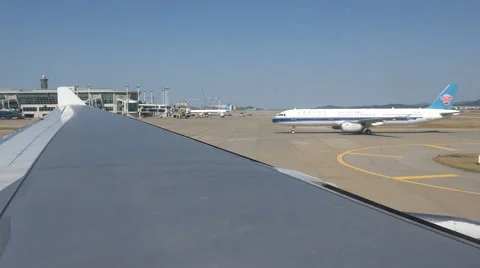 Wing tip, Korean Air flight taxi towards runway Incheon Airport in South Korea Stock Footage 60795616