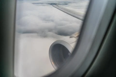 Wing, turbine, engine and window of a plane. Stock Photos
