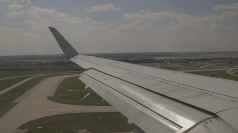 Wing View On Plane Making A Landing On The Airport Runway Video stock 118097269