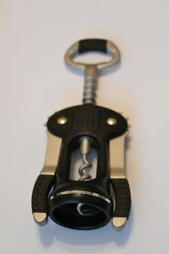 Winged corkscrew on a white surface Photos