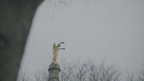 Winged Statue Atop Column Against Overcast Sky Stock Footage 341343067
