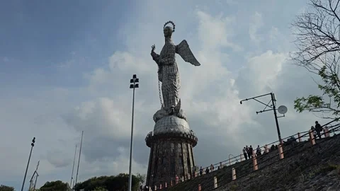 Winged Virgin Statue and Hillside Visitors Below Cloud, El Panecillo, Ecuador 8K Stock Footage 331495705