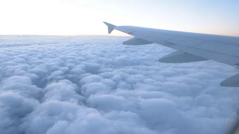 Wings of an airplane above the clouds, background Stock Footage 79995714