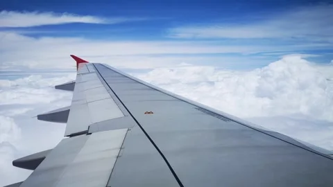 Wings of the airplane during the flight look from the passenger window Video stock 283066199