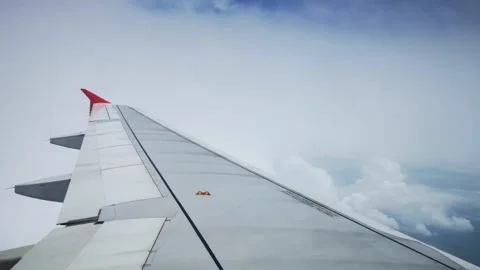 Wings of the airplane during the flight look from the passenger window Video stock 283066200