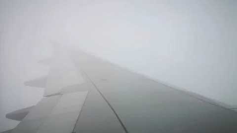 Wings of the airplane during the flight look from the passenger window Video stock 283068651