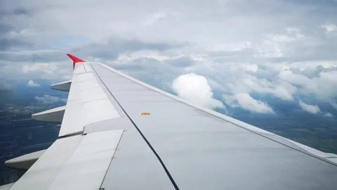 Wings of the airplane during the flight look from the passenger window Video stock 283068709