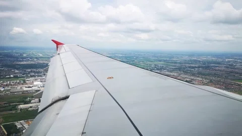Wings of the airplane during the flight look from the passenger window Video stock 283069140