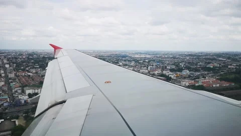 Wings of the airplane during the flight look from the passenger window Video stock 283070535