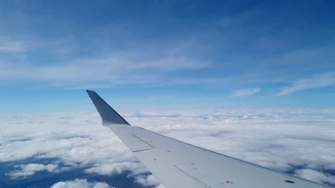 Wingside view of plane flying above the clouds Video stock 107453804