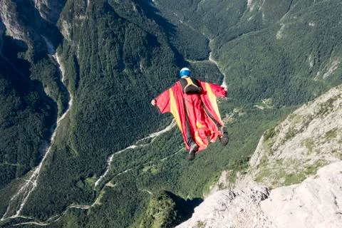 Wingsuit BASE jumper is flying down, Italian Alps, Alleghe, Belluno, Italy Stock Photos