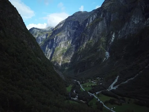 Wingsuit Base Jumper Swoops into a Classic Glacial Valley Aerial Scene Stock Footage 80889034